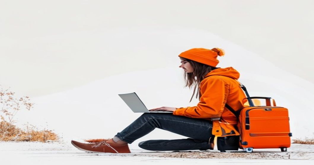 nomad freelancer with luggage working on laptop outdoors